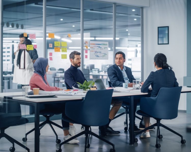 Team meeting in the conference room centered around how to manage it infrastructure better.